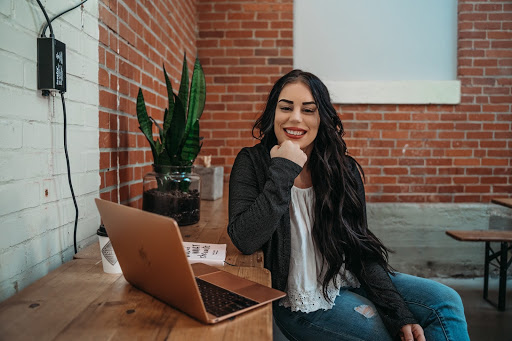 The author, Hailey Lucas sitting at a laptop