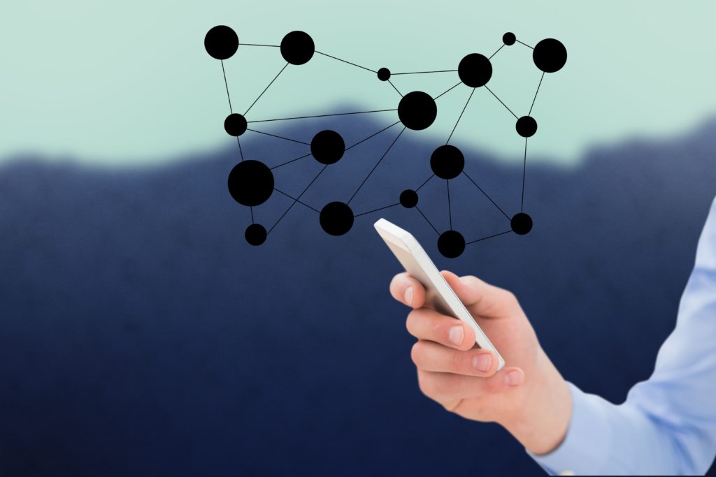 Person holding smartphone with digital network, symbolizing how digital native clients prefer seamless online booking.