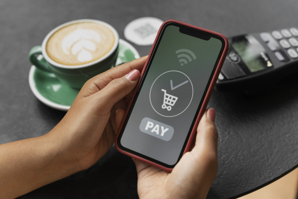 Person using smartphone for contactless payment, illustrating Gen Z booking habits favoring digital transactions.