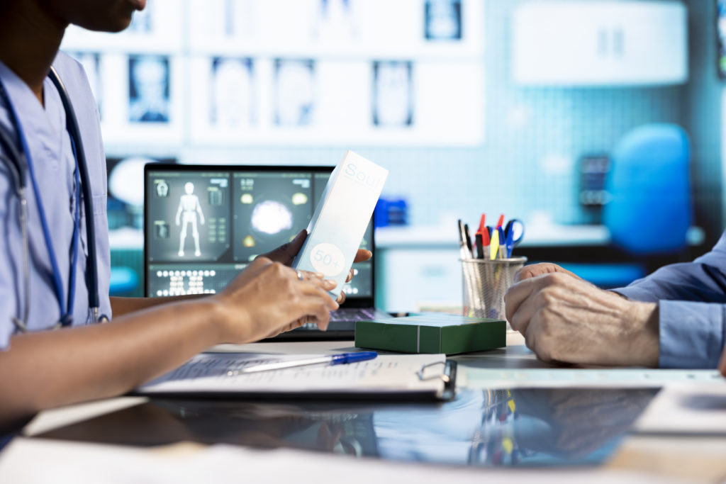 Healthcare team reviewing charts. Streamline patient appointment management with SimplyBook.me.