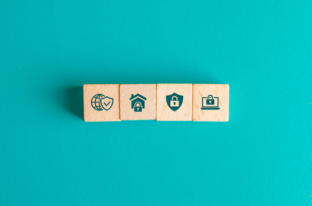 Wooden blocks with padlock security icons on teal background, representing secure enterprise scheduling software.